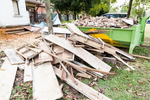 Builders waste clearance team removing rubble from a London renovation site