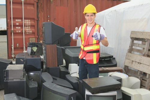 Furniture removal team handling bulky items in a London residential street