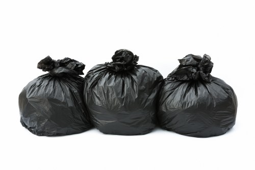 Workers assessing hazards during a waste removal task